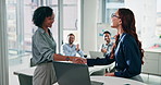 Woman, team and shaking hands for presentation in office with laptop, feedback and goals at finance company. Person, pitch and pc with group for support, handshake or motivation at investment agency
