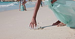 Beach, cleaning and hands of person with litter, plastic bottle and collect rubbish for recycling. Volunteer, nature and people with trash bag for garbage, pollution and dirt for environmental care