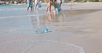 Volunteer, cleaning and plastic bottle on beach with people for collection, recycling and conservation. Team, nature and activist with trash bag for garbage, pollution and dirt for environmental care