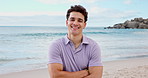 Happy, crossed arms and face of man by beach on holiday, getaway or weekend trip in summer. Smile, confident and portrait of male person by ocean for relax on seaside vacation or travel in Brazil.