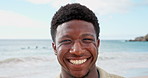 Happy, laugh and face of black man by beach on holiday, getaway or weekend trip in summer. Smile, confident and portrait of African male person by ocean for relax on seaside vacation or travel.