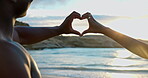 Love, heart hands and travel with couple at beach for bonding, romance and summer vacation. Honeymoon getaway, commitment and care with people outdoor for connection, holiday date and marriage