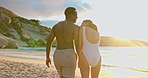 Back, couple or walking with laugh on beach for summer getaway, tropical adventure or funny joke. Sunshine, happy interracial people or holding hands at ocean for vacation, bonding or love with flare