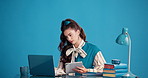 Business woman, typing and laptop in studio for planning, productivity and project management. Aesthetic, journalist and employee with tablet, research and creative publisher on blue background