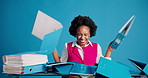 Frustrated, woman and documents with chaos in studio for overwhelming workload on a blue background. Angry, female person or employee pushing paperwork on desk with stress for deadline or pressure