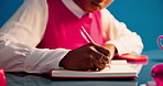 Business woman, hands and writing for planning, productivity and project management in studio. Aesthetic, journalist and employee with notebook, research and creative publisher on blue background