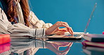 Business woman, typing and laptop for schedule, productivity and project management in studio. Aesthetic, journalist and employee with tablet, research and creative publisher on blue background