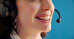 Call center, headset or mouth in studio with laugh, support or contact us in crm management. Telemarketing, woman or agent on blue background with tech, customer service or feedback in help desk.

