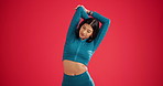 Exercise, stretching and woman in studio for fitness, warm up routine and arm muscle relief activity. Start training, athlete and getting ready for workout on red background, body wellness and space