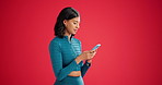 Phone, typing and woman in studio for schedule, communication and smile for sign up on space. Message, texting or health tracking update with coach, personal trainer and mockup on red background