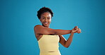 Workout, stretching or black woman in studio for fitness, warm up routine or arm muscle relief. Start training, happy athlete or getting ready for exercise on blue background, body wellness or space