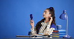 Handheld fan, business and woman in studio, completed assignment and relax on blue background. Space, professional and person at desk, finished task and cool down on break, rest and close laptop