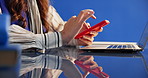 Cellphone, hands and businesswoman in studio for networking, contact or texting on mobile app. Technology, connectivity and female creative editor on phone for communication by blue background.