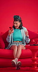 Surprise, cellphone or woman on couch in studio, facial expression or announcement. Wow, excited and person on sofa, smartphone for online news or app for social media or reaction on red background