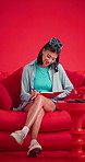 Studio, woman and writing in notebook on couch for creative idea, list or planning for novel. Sofa, person and writer with diary for story, journal reminder or smile for inspiration on red background