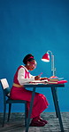 Education, studying and black woman with books for learning with university test, exam or assignment. Lamp, writing and African female student with laptop for research on college project by blue wall