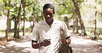 Student, walking and black man in city, cellphone for texting and message to contact. University, morning or African person in street, smartphone and digital app for social media or online chatting