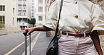 Business, woman and hand in city with suitcase, international travel and commute for work conference. Professional person, walk and journey in urban town with luggage, job opportunity and convention.