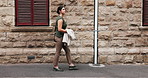 Business, woman and walk in city with journey, brand management career and morning commute to work. Female person, outdoor and travel in urban town with bag, thinking and vision for advertising job.