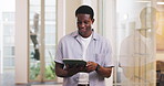 Creative, black man and scroll in office with tablet, research or planning for public relations project. Person, typing and reading in PR agency with tech, website and email for online press release.