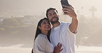 Happy couple, beach and hug with selfie for memory, travel or photography together in nature. Man, woman and love with smile, picture or embrace for capture moment or social media post on ocean coast