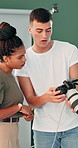 People, photographer and edit with camera for production, retouch or inspection in studio. Man, woman or discussion with photography for commercial business startup or digital agency in workplace