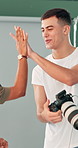 Happy people, photographer or high five with camera for production success or teamwork in studio. Excited, man or woman with smile or photography for commercial business startup together in workplace
