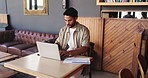 Freelancer, typing and man with laptop in coffee shop for remote work, document and inspiration. Creative journalist, idea and person with tech in cafe for copywriting, paperwork and digital report