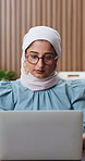 Laptop, research and muslim woman in office with glasses, creativity and project for digital marketing. Islamic person, reading or browse in workplace with computer, advertising campaign or planning.