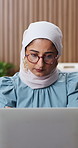Laptop, reading and muslim woman in office with glasses, creativity and project for digital marketing. Islamic person, research or review in workplace with computer, advertising campaign or planning.