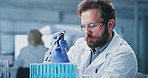 Science, research and man in lab, test tube for experiment and solution for vaccine. Scientist, employee and person in workplace, medical info and study for pharmaceutical sample and biotech analysis