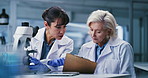 Women, scientist and team with clipboard at lab for discussion, review and notes for medical research. People, feedback and point with checklist, pharmaceutical study or vaccine development for virus