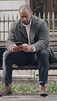 Reading, phone or businessman on bench in city, typing email or message notification for connectivity. News, check inbox or person with mobile for texting, online chat response or networking in town