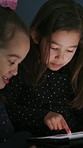 Tablet, movie and kids in home at night for watching series, show or video together on weekend. Friends, bonding and girl children with digital technology for streaming film in bedroom at house.