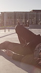 Skater, accident and man in city, fail and training for technique, lens flare and fitness. Outdoor, skateboard and person in park, balance and joint injury with pain, inflammation and muscle pain