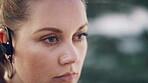 Earphones, fitness and thinking with woman on beach for recovery or rest from training routine, Exercise, ideas and vision with serious person outdoor for health, cardio workout or wellness activity