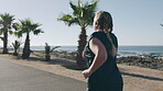 Overweight, woman and running for fitness at beach with exercise, training and cardio challenge. Back, plus size person and lose weight with workout, endurance performance and wellness on promenade