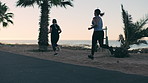 People, friends and running for fitness at beach with exercise, training and cardio challenge. Back, women or lose weight with morning workout, endurance performance and wellness on promenade outdoor
