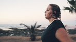 Woman, fitness and running with earphones for sprint, weightloss or outdoor workout on ocean coast. Active, female person or runner with race or exercise for cardio training, health or wellness