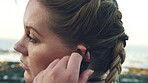 Break, earphones and fitness with woman on beach for recovery or rest from training fatigue, Exercise, thinking and tired with exhausted runner outdoor for health, cardio workout or wellness