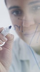 Woman, scientist or writing with glass board for planning, problem solving or solution in lab. Female person, doctor or employee taking notes with equation for schedule, brainstorming or clinic trial