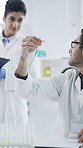 Speaking, science and people with beaker in lab, chemical compound experiment and medical research team. Talk, solution reaction and scientist writing for observation notes, trial and vaccine testing