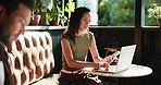 Laptop, phone and remote work with woman in cafe for communication, planning or research. App, computer and reading text message with freelance employee in coffee shop or restaurant for review