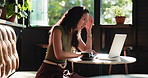 Laptop, remote work and stress with woman in coffee shop planning, problem solving or research. Computer, thinking and typing with unhappy freelance employee in cafe or restaurant for frustration