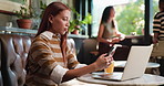 Phone, laptop and woman in cafe with texting, social media or typing email on mobile app. Technology, notification and female person with computer and cellphone for chatting on website in coffee shop
