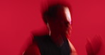 Running, fitness and man in studio for exercise, training or wellness with active challenge. Athlete, sports and male person with cardio workout for sprinting, health and endurance by red background.