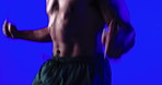 Hands, skipping and rope for fitness in studio with jumping, balance or intense training on blue background. Person, gear and shirtless for exercise, cardio challenge and workout for wellness at gym
