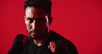 Fitness, boxing and face of man in studio for workout, self defense or training for competition with active. Sports, portrait and male person with gloves for fighting or exercise by red background.
