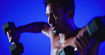 Fitness, weightlifting or person in studio with dumbbells, shirtless or bicep power in bodybuilding. Intense, strong or man with equipment, topless workout or muscle transformation on blue background