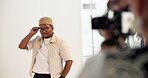 Man, fashion and model with photographer in studio for photoshoot, film set and production. Male person, glasses and posing with cameraman for magazine casting, advertising clothes and media campaign